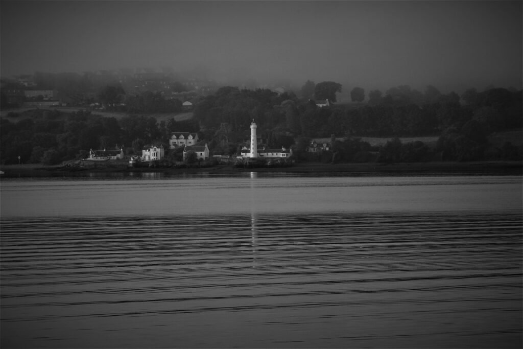 Lighthouse Through A Hazy Summer Morning